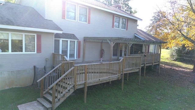 back of property with a pergola, a wooden deck, and a yard