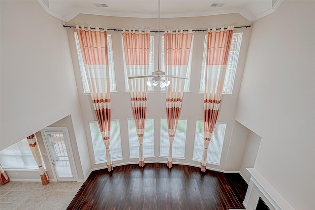 doorway to outside with ceiling fan, hardwood / wood-style floors, and ornamental molding