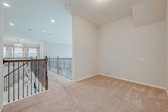 carpeted spare room featuring ceiling fan