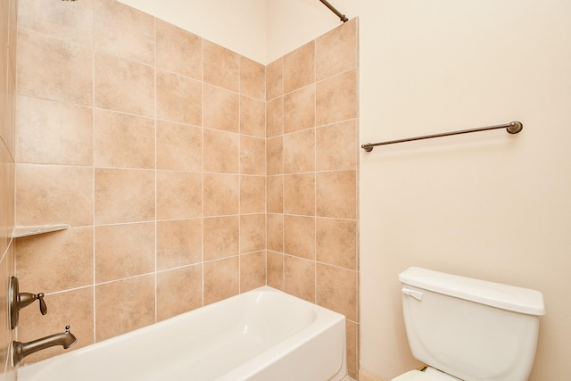 bathroom featuring toilet and tiled shower / bath