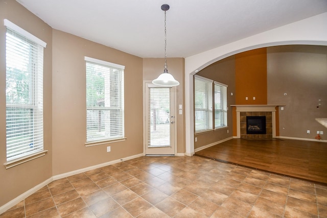 entryway featuring a tile fireplace and hardwood / wood-style floors