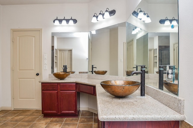 bathroom featuring tile patterned flooring, vanity, and a shower with shower door