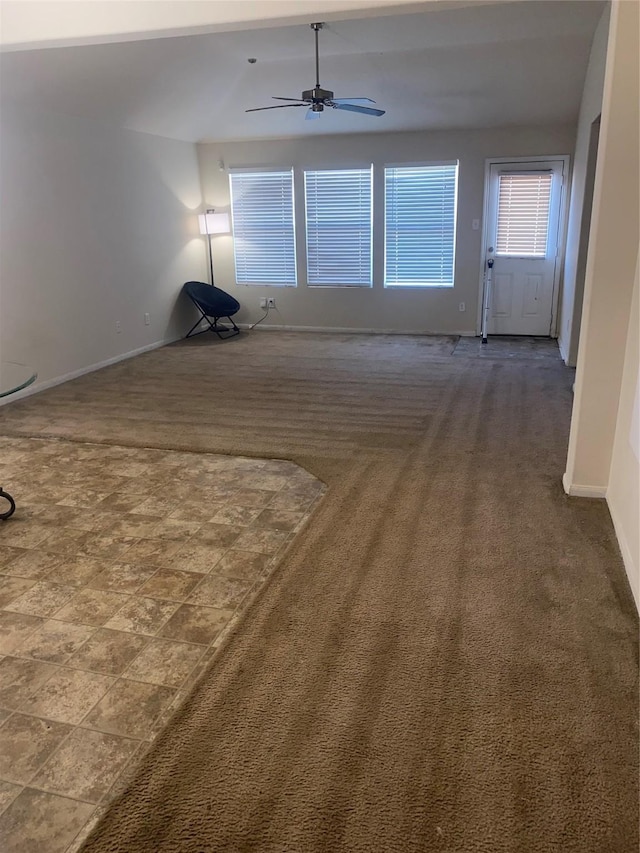 empty room with ceiling fan and carpet