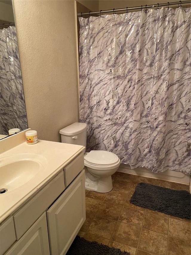 full bathroom featuring vanity, toilet, and shower / tub combo with curtain