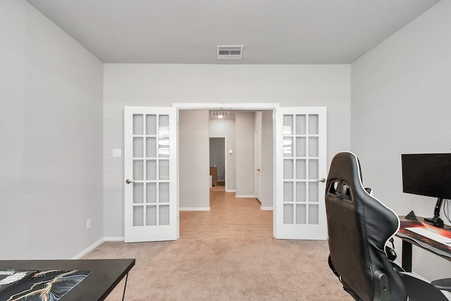 office space with light carpet and french doors