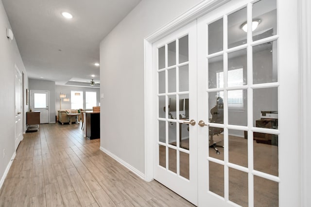 hallway featuring french doors and light wood-type flooring