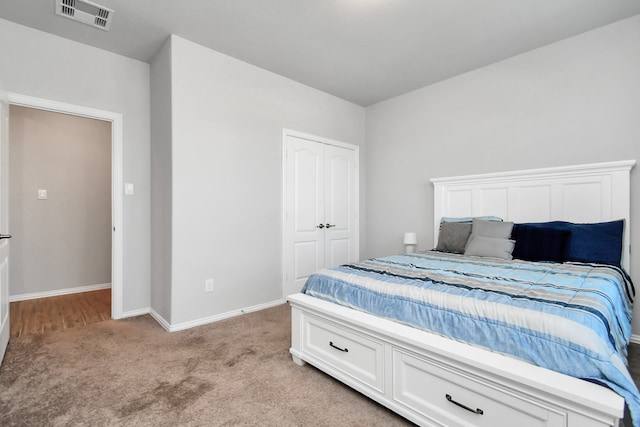 carpeted bedroom featuring a closet