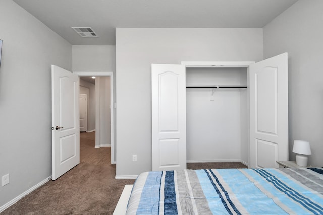 unfurnished bedroom featuring dark carpet and a closet