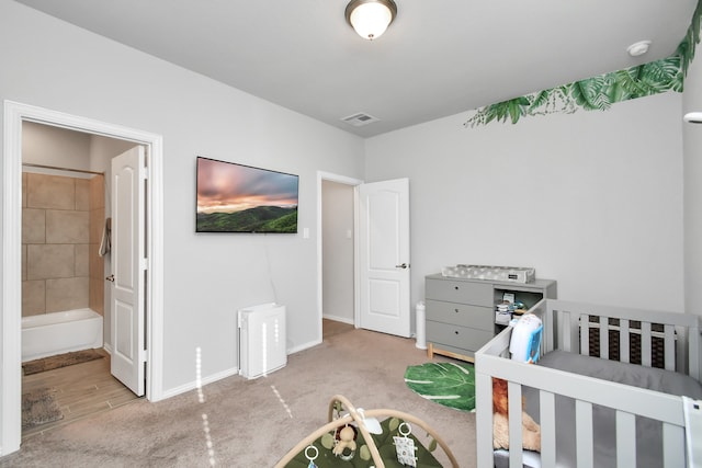 carpeted bedroom with ensuite bath