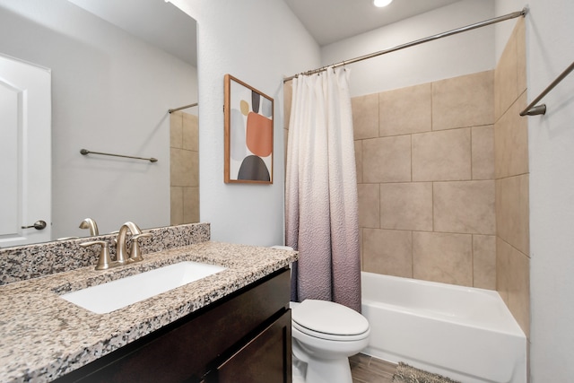 full bathroom featuring hardwood / wood-style floors, vanity, shower / bath combo, and toilet