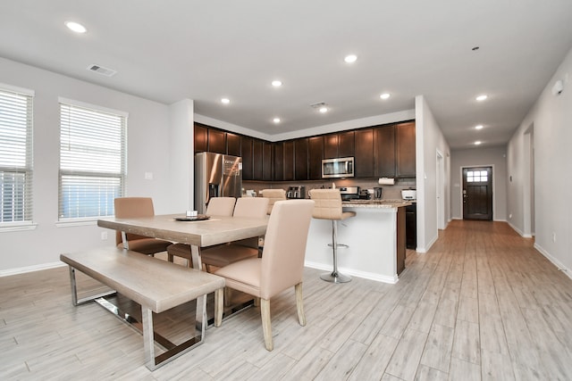 dining space with light hardwood / wood-style floors