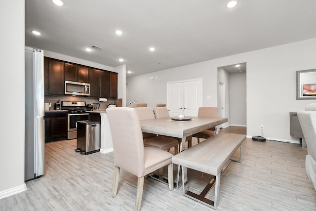 dining space with light hardwood / wood-style flooring