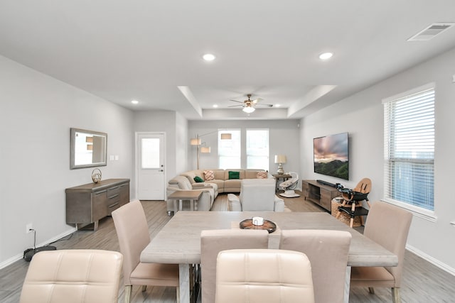 dining area with ceiling fan and hardwood / wood-style floors