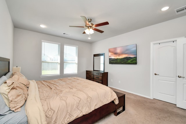 bedroom featuring ceiling fan and light carpet