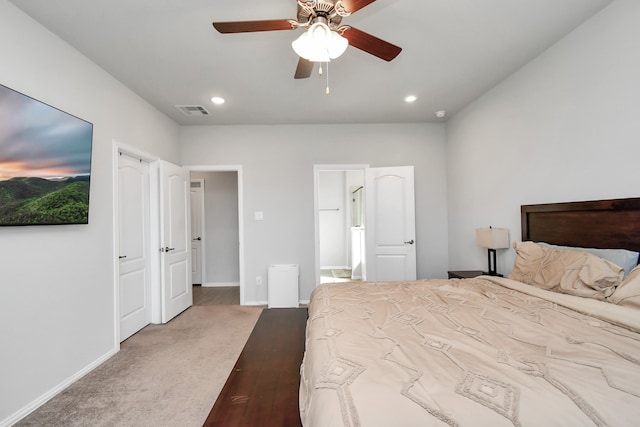 bedroom with carpet, connected bathroom, and ceiling fan