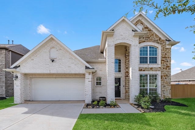 view of front of house featuring a garage and a front lawn