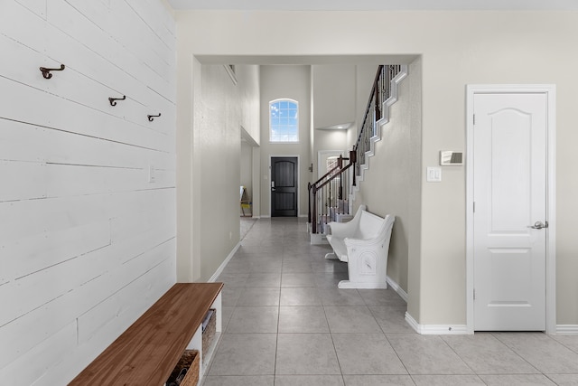 interior space featuring light tile patterned floors and a high ceiling