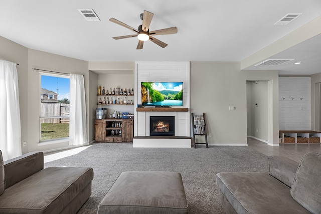 unfurnished living room featuring carpet flooring, ceiling fan, and a fireplace