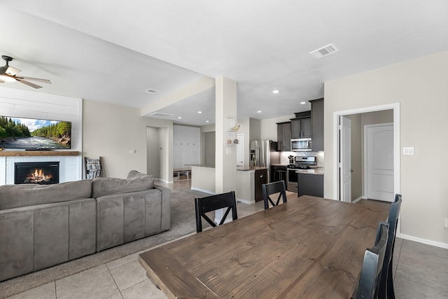 dining room featuring ceiling fan and light tile patterned flooring