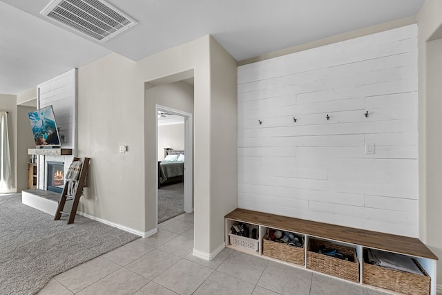 mudroom with light colored carpet