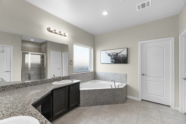 bathroom featuring tile patterned floors, separate shower and tub, and vanity