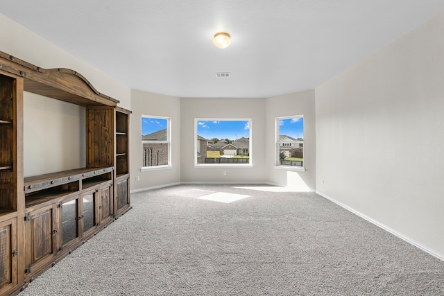 unfurnished living room featuring light colored carpet