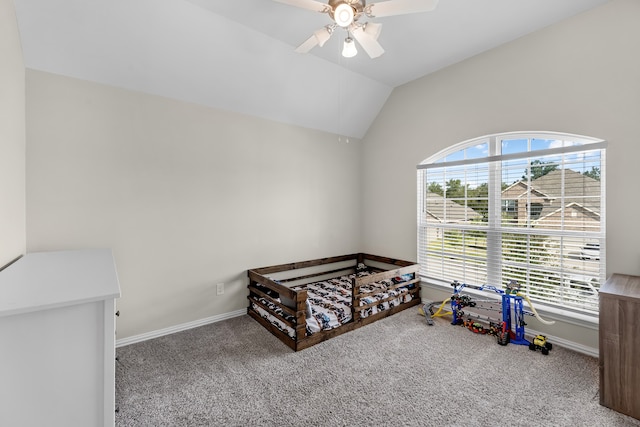 bedroom featuring carpet floors, vaulted ceiling, multiple windows, and ceiling fan