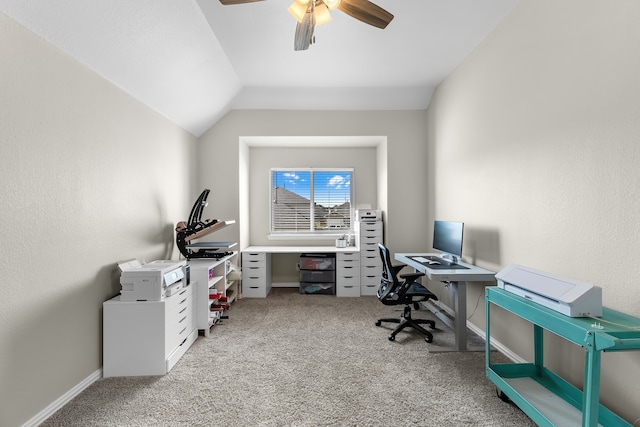 carpeted office space with ceiling fan and vaulted ceiling