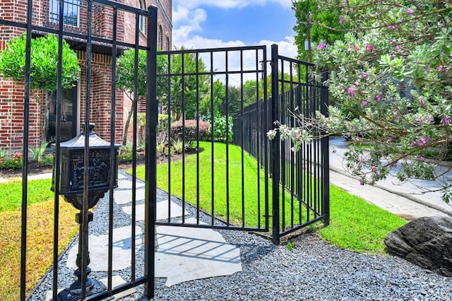 view of gate featuring a yard