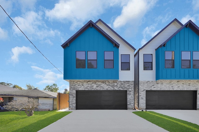 view of front of home with a garage and a front lawn