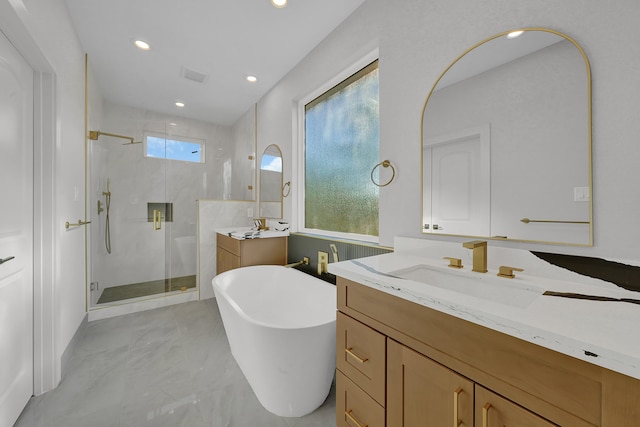 bathroom featuring vanity and separate shower and tub