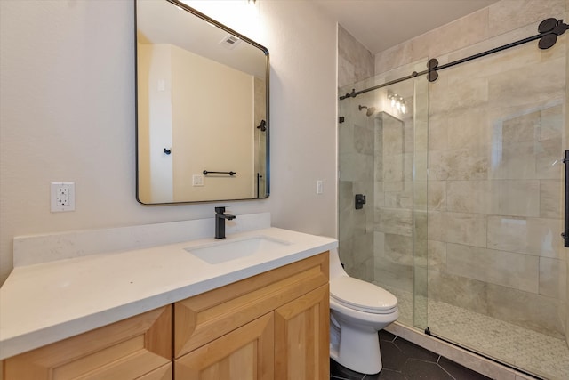 bathroom with walk in shower, tile patterned floors, vanity, and toilet