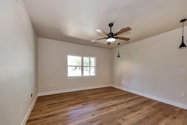 empty room featuring hardwood / wood-style floors and ceiling fan