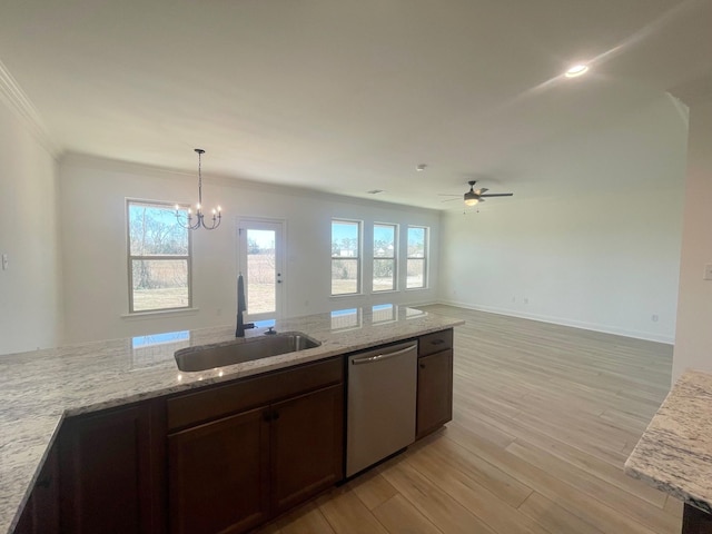 kitchen with a sink, light wood-type flooring, light stone counters, and dishwasher