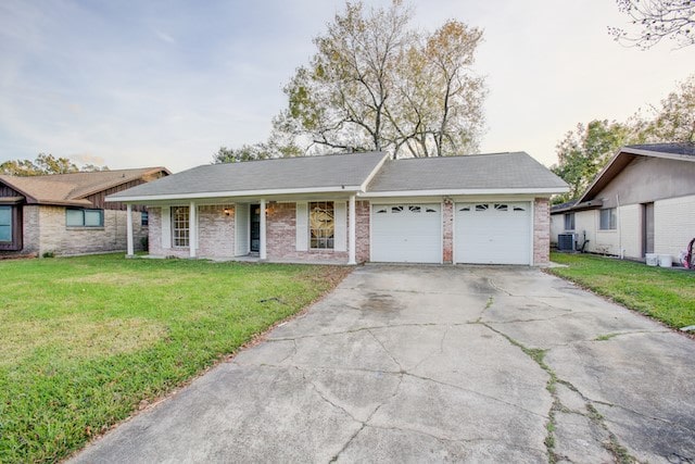 ranch-style home with a garage, central air condition unit, and a front lawn