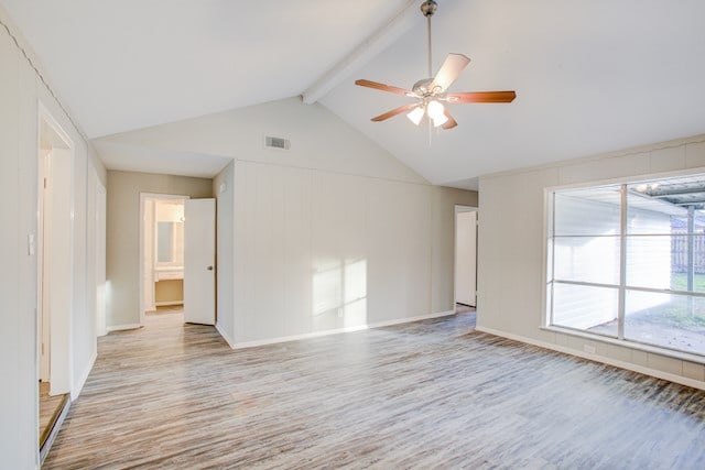 spare room with lofted ceiling with beams, ceiling fan, and light wood-type flooring