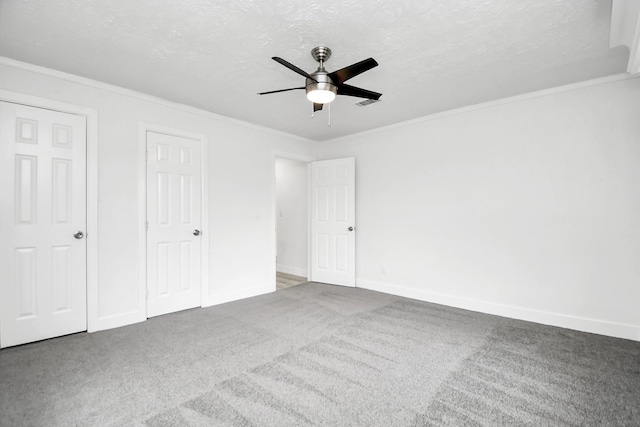 unfurnished bedroom with ceiling fan, crown molding, carpet floors, and a textured ceiling