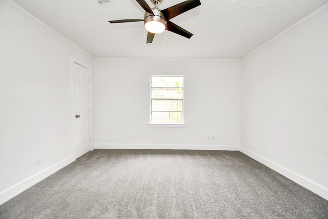 empty room featuring crown molding, carpet, and ceiling fan