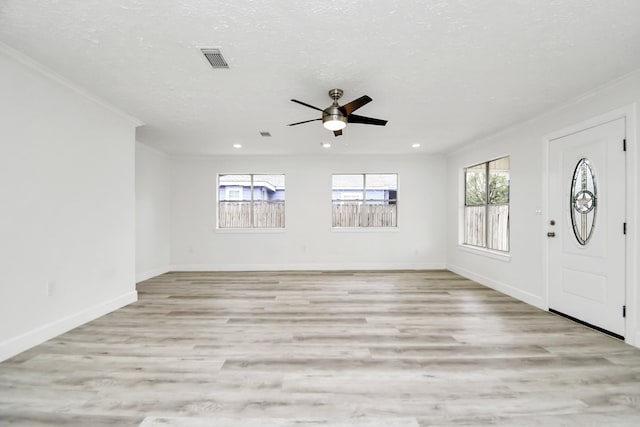 foyer entrance featuring light wood-type flooring, ceiling fan, and ornamental molding