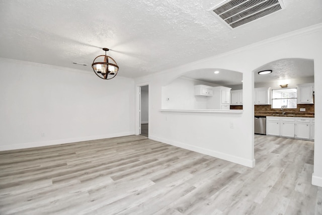 unfurnished living room with ornamental molding, sink, and light hardwood / wood-style flooring