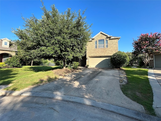 view of property hidden behind natural elements featuring a garage and a front lawn