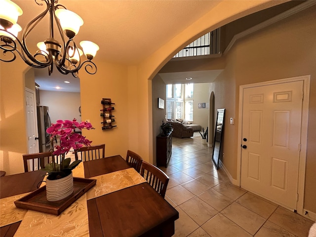 dining room featuring light tile patterned flooring, a chandelier, and a textured ceiling