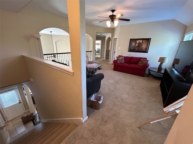 living room with light carpet, ceiling fan, and vaulted ceiling