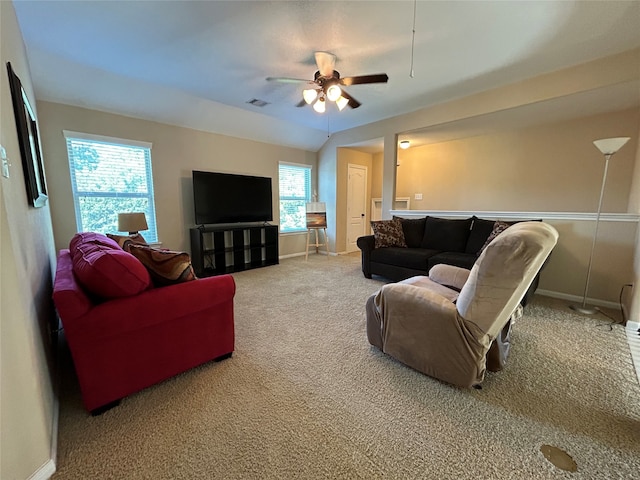 carpeted living room featuring ceiling fan and a wealth of natural light