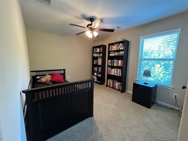 bedroom featuring ceiling fan and light colored carpet