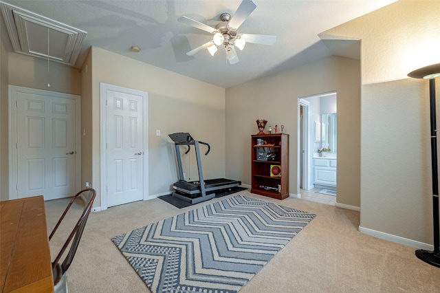 workout room featuring light carpet and ceiling fan