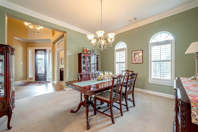 dining room with plenty of natural light, light colored carpet, and an inviting chandelier