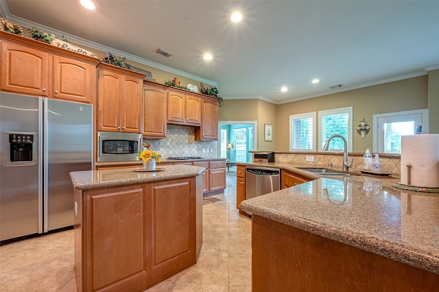 kitchen with crown molding, sink, a kitchen island, and appliances with stainless steel finishes