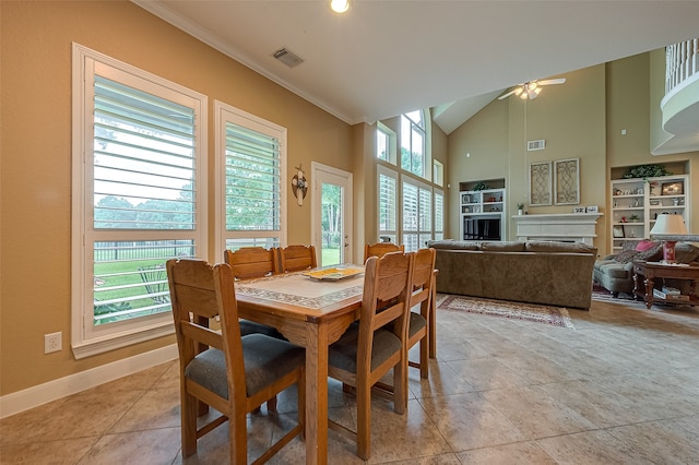 dining room with ceiling fan, high vaulted ceiling, a healthy amount of sunlight, and ornamental molding