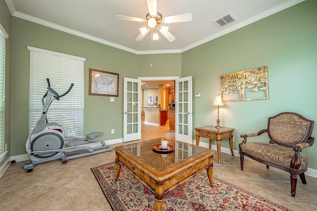 tiled living room with ceiling fan, french doors, and ornamental molding